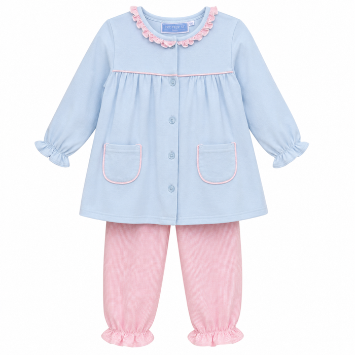Girls blue top with pink ruffle collar and button front, paired with pink gingham bloomer pants with ruffle hems.