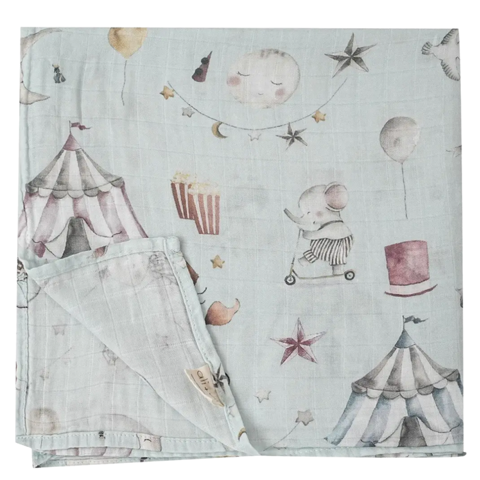 Bamboo muslin baby swaddle blanket featuring a whimsical watercolor circus print with elephants, circus tents, balloons, stars, and moon.