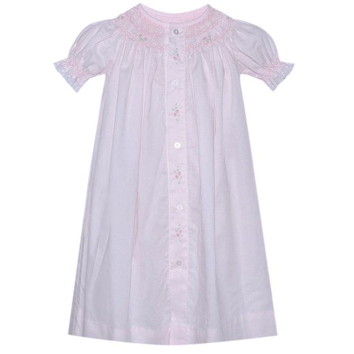 Baby girls pale pink smocked bishop style daygown with embroidered floral details and puff sleeves on white background