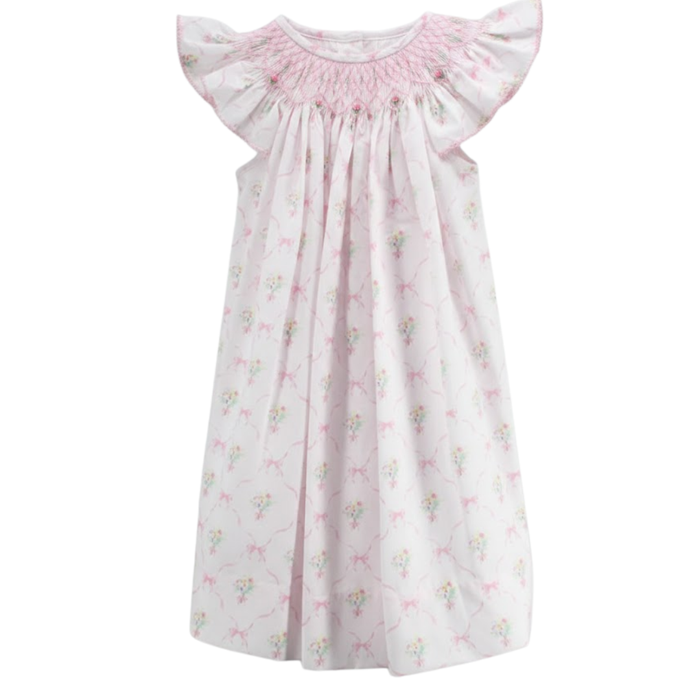 Girls pink smocked dress with floral and bow print and flutter sleeves on white background