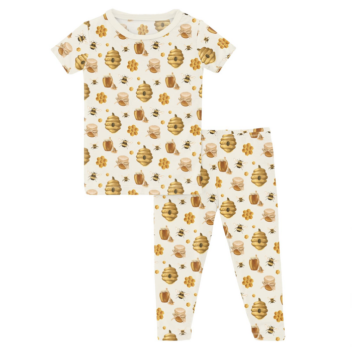 Children’s bamboo pajama set with honey bee, hive, and honeycomb print featuring a short sleeve top and matching long pants.