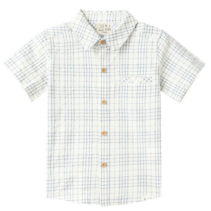 Boys cream short sleeve button down shirt with light blue plaid pattern and chest pocket on white background.
