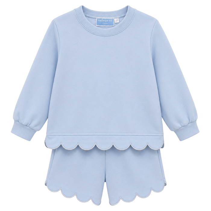 Girls light blue two-piece set with long sleeve top and scalloped hem shorts, featuring soft fabric and a relaxed fit.