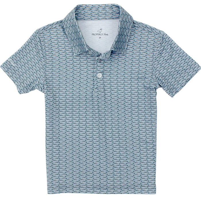 Boys blue short sleeve polo shirt with small repeating trout print and two-button collar.