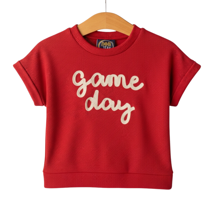 Girls red short sleeve ribbed top with cream “game day” script lettering on hanger
