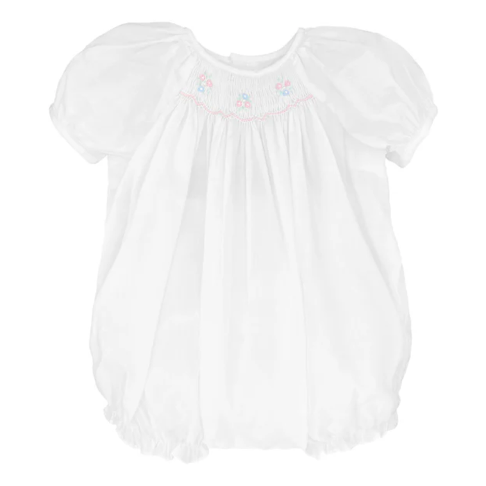 White baby smocked bubble romper with puff sleeves and embroidered neckline, photographed on a clean white background.