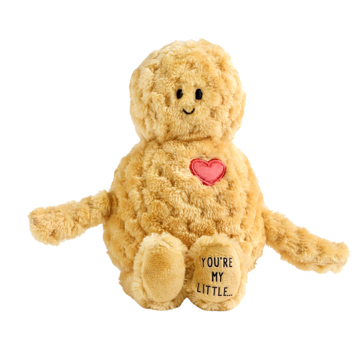 Soft tan peanut-shaped plush toy with textured fur, embroidered face, red heart patch, and “You’re My Little…” on the foot, displayed on a white background.