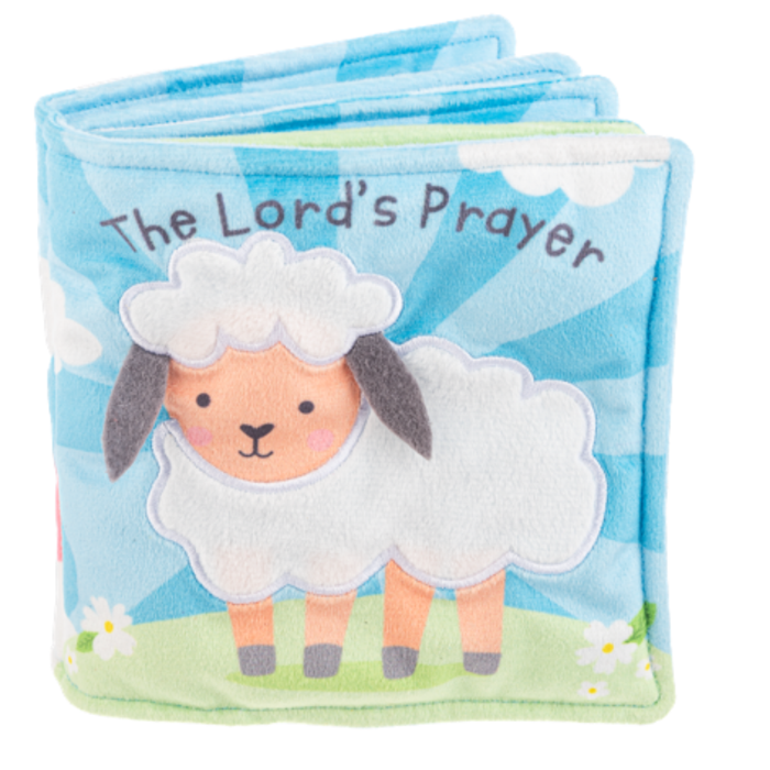 Soft fabric baby book titled “The Lord’s Prayer” with a lamb illustration on a blue and green background.