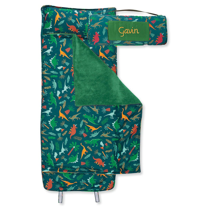 green nap mat with dinosaurs on it