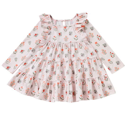 Girls pink floral tiered dress with ruffle shoulders and long sleeves on a white background.