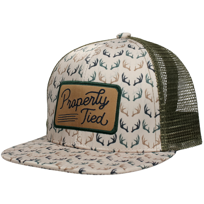 Boys trucker hat with antler print, mesh back, and Properly Tied patch on front.