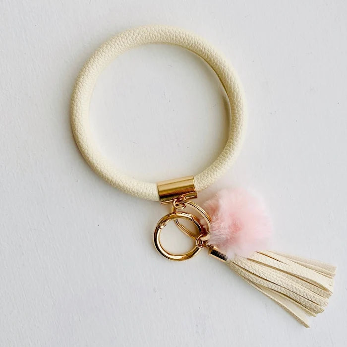 solid cream bangle with light pink pom pom and cream fringe
