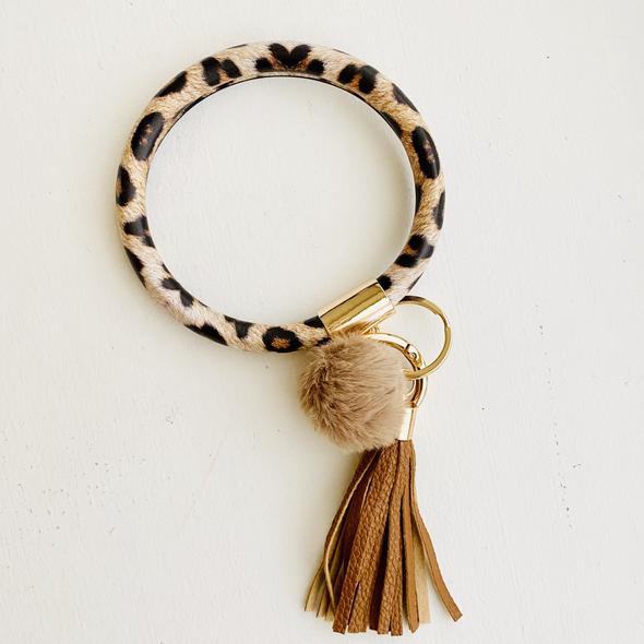 leapord print bangle with a light brown pom pom and a light brown fringe