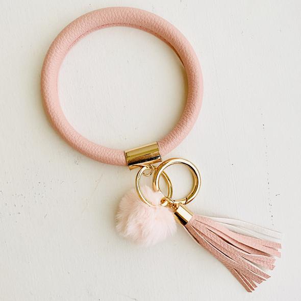 light pink bangle with a light pink pom pom and a light pink fringe