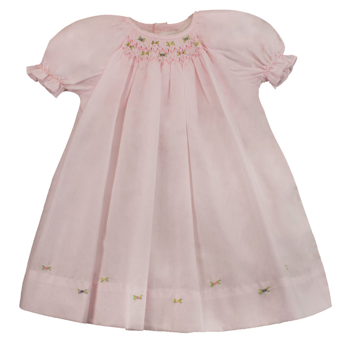 Pink dress smocked with roses on the hemline.