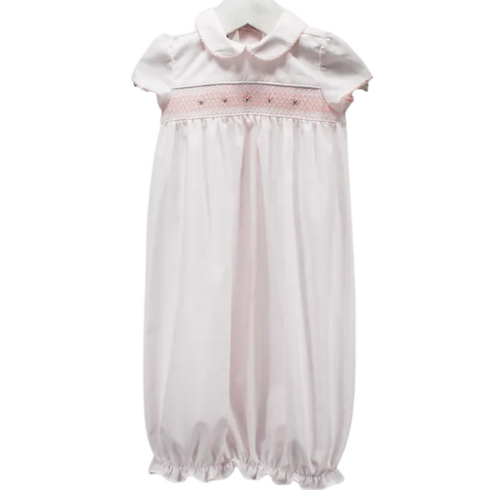 pink gown with rose smocking and a rounded collar with pink trim.