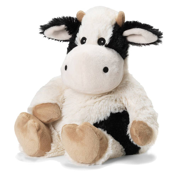 A plush black and white cow warmie on a white background