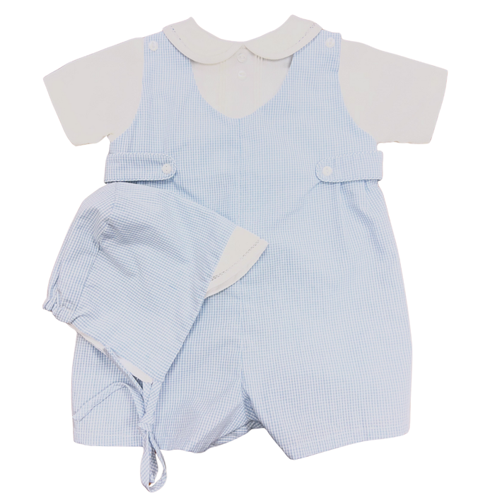 Baby boy blue micro check romper worn over white collared shirt with matching bonnet, photographed on a white background.