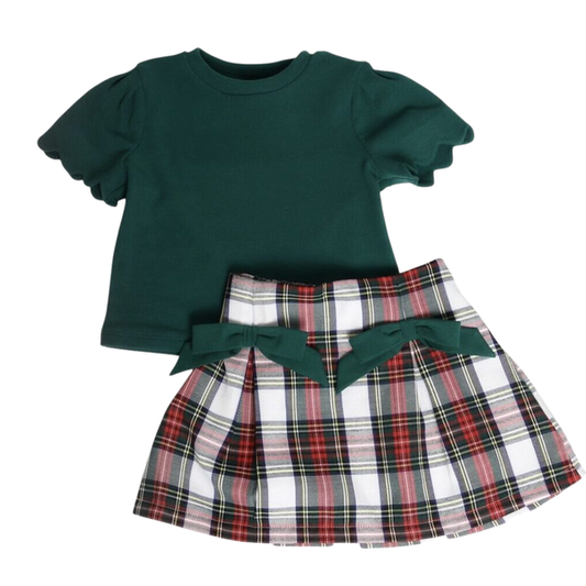 Girls holiday outfit with green puff sleeve top and red green plaid skirt with bow waistband on white background