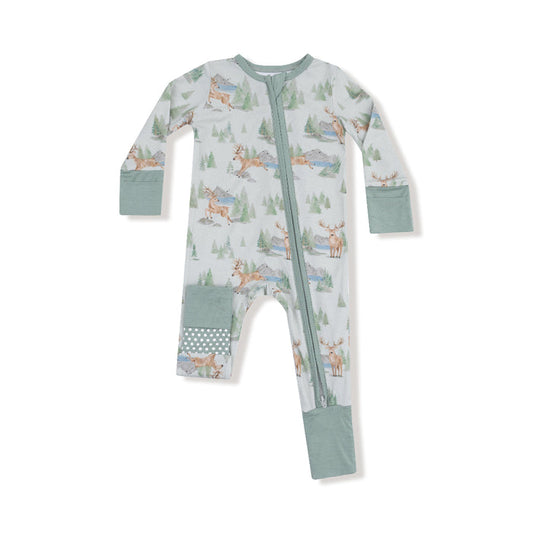 Baby romper with watercolor deer and pine tree print, green cuffs, two-way zipper, and polka dot foot and knee patches.