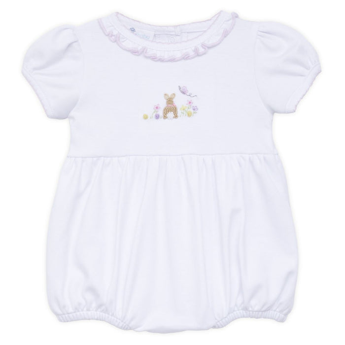 White baby bubble romper with puff sleeves, ruffled neckline, and embroidered bunny with flowers displayed on a white background