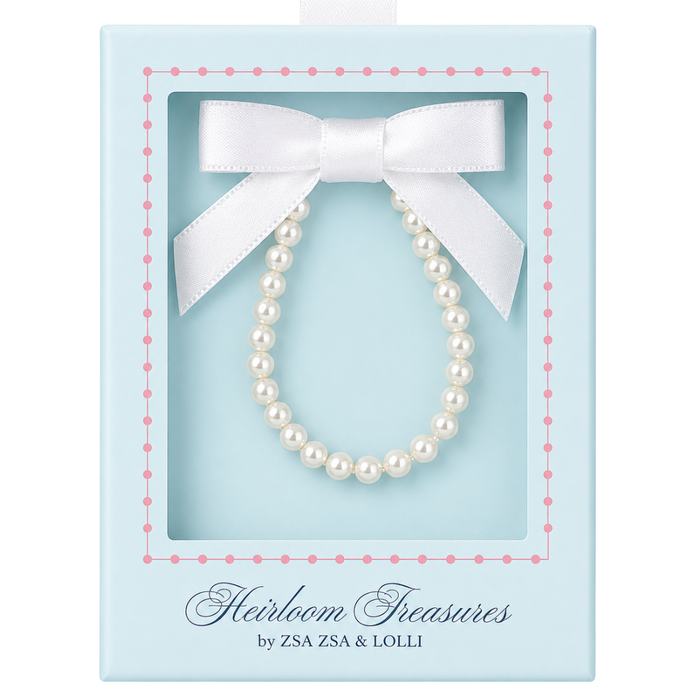 crystal pearl baby bracelet  in a decorative box with a white bow, branded 'Heirloom Treasures by ZSA ZSA & LOLLI'.