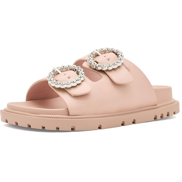 Blush pink girls slide sandal with oversized crystal buckle and textured lug sole.