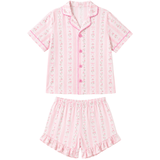Girls’ pink and white pajama short set featuring floral stripes, bow details, a button-down collared top, and ruffled shorts.