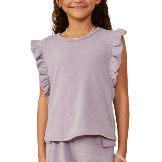Tween girl wearing a pink waffle knit button front top with rolled sleeves and textured fabric.