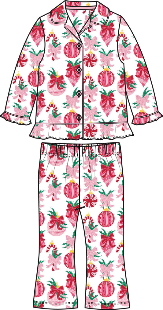 Girls two-piece Christmas pajama set with pink ornament, bow, and candy cane print, featuring a button-up top and matching pants.