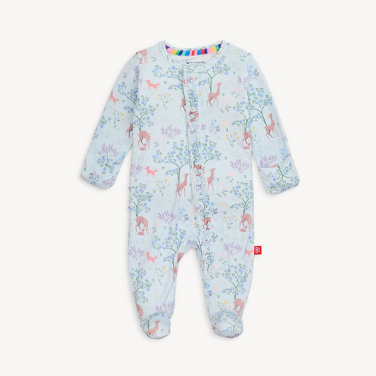 Baby wearing a soft TENCEL™ modal footie sleeper with magnetic closures and fold-over mittens for cozy, all-day comfort.