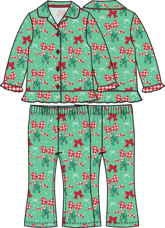 Girls green Christmas pajama set with red bows, gingham ribbon, and mistletoe print, featuring a button-up top and matching pants.