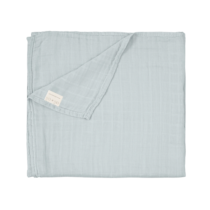 Solid misty sky blue bamboo muslin baby swaddle blanket folded to showcase its soft, breathable fabric.