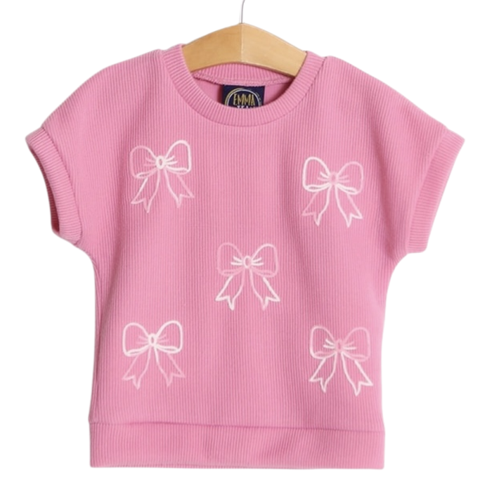 Girls pink ribbed short sleeve top with white bow embroidery and relaxed fit on hanger