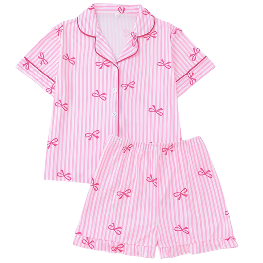 Pink striped girls pajama set with bow print featuring short sleeve button-front top and matching elastic waist shorts.