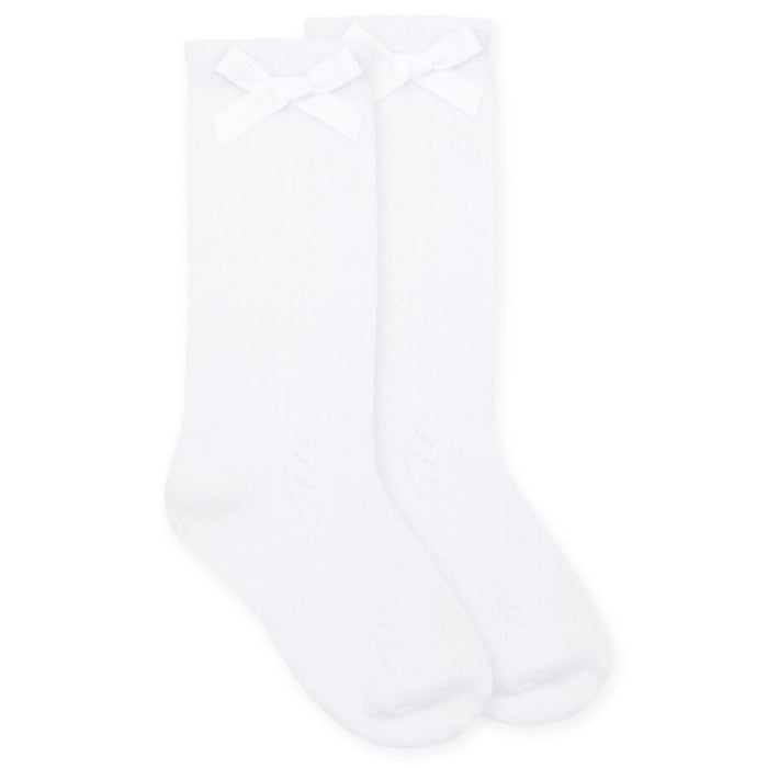 white knee high socks with white ribbon bows on the top