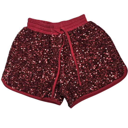 Red girls pull-on shorts covered in red sequins with elastic waistband and drawstring detail.