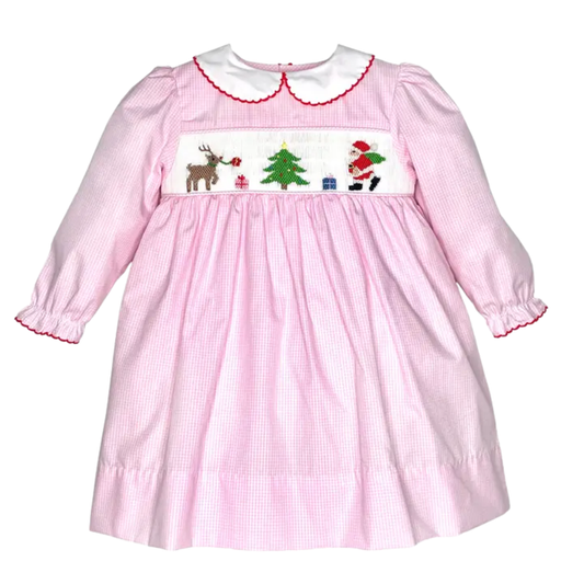Girls pink gingham Christmas dress with smocked Santa, reindeer, tree and gifts, plus a white Peter Pan collar and long sleeves.