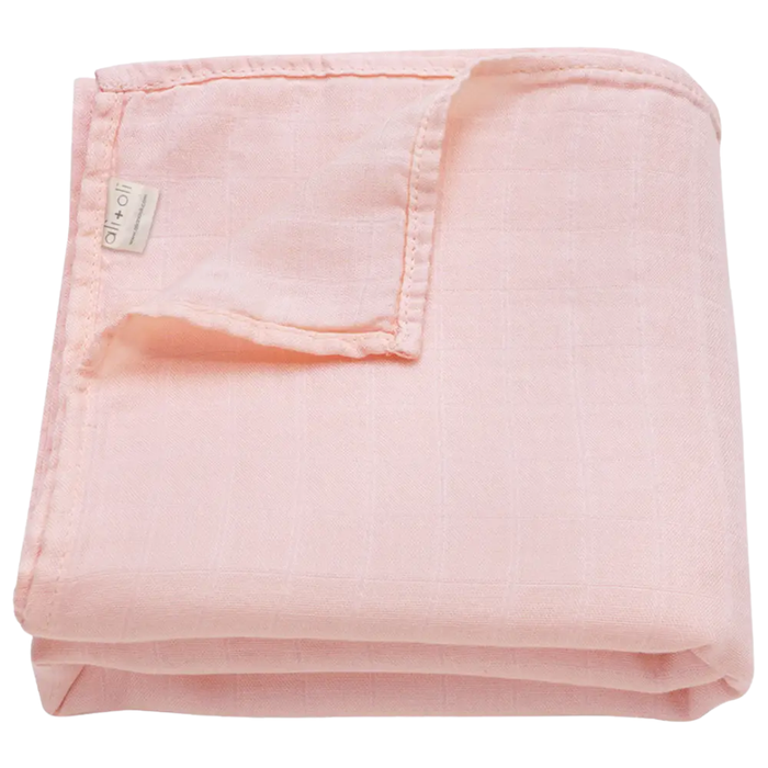 Solid soft pink bamboo muslin baby swaddle blanket folded to showcase its lightweight, breathable fabric.