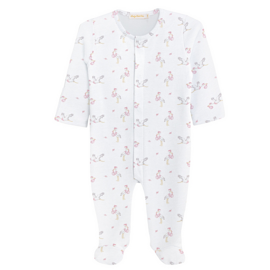 White baby footie with long sleeves, covered feet, and a pink stork print pattern carrying tiny pink bundles, featuring a snap-front closure.