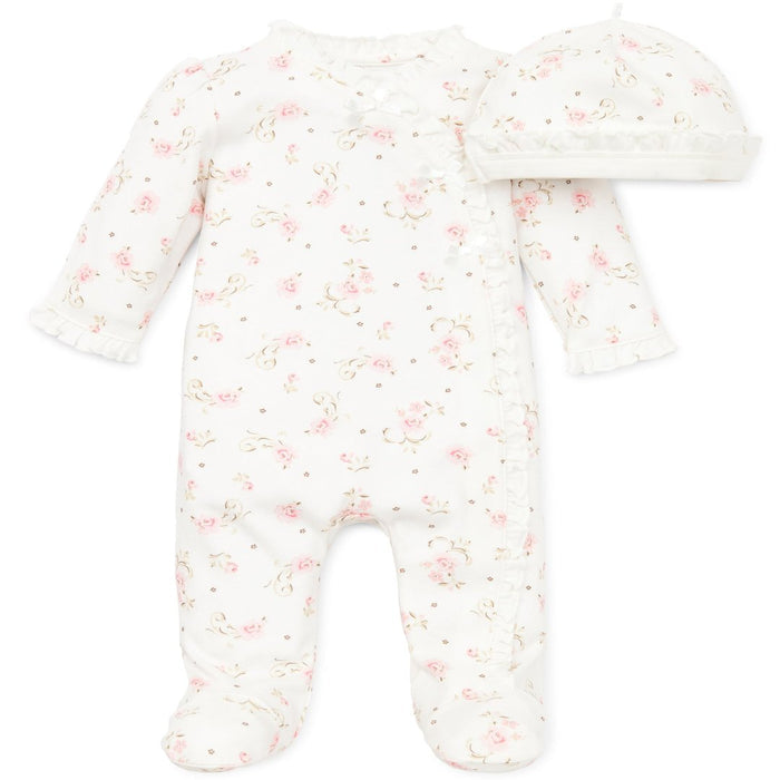white footie with a pink flower print and a matching hat.